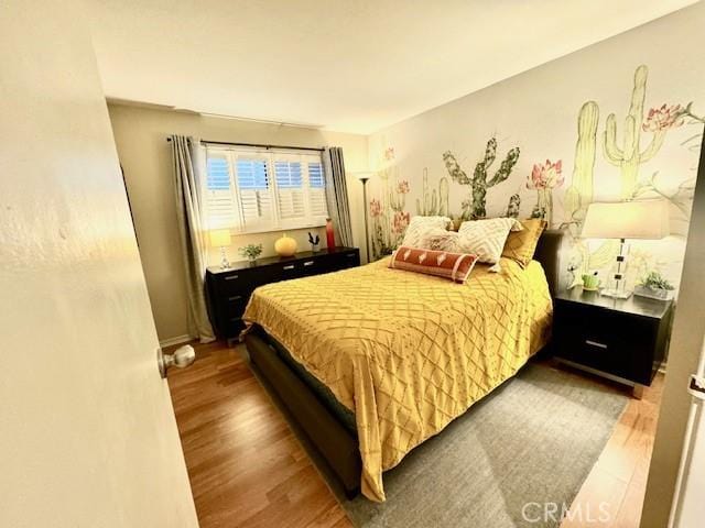 bedroom with wood finished floors