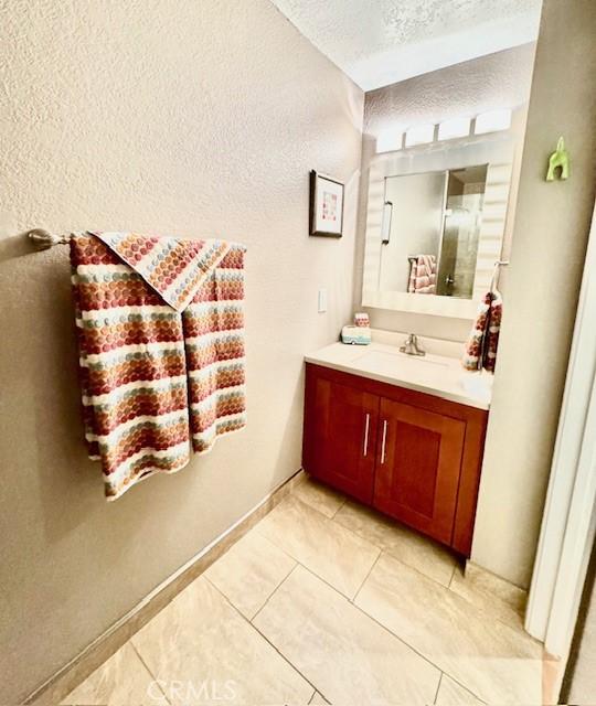 bathroom featuring vanity and a textured ceiling