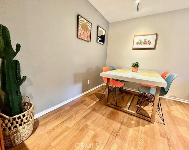 dining area featuring light wood-style floors and baseboards