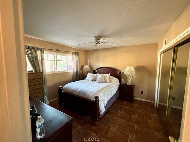 bedroom with ceiling fan and a closet