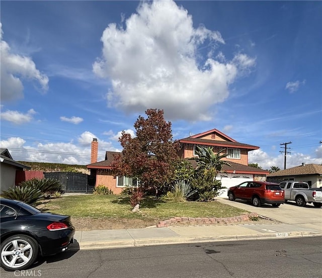 obstructed view of property with a front lawn