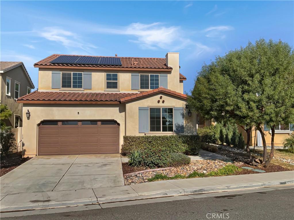 1480 Marble Way, Beaumont, CA 92223 - mediterranean / spanish-style home featuring driveway, an attached garage, solar panels, a tile roof, and stucco siding