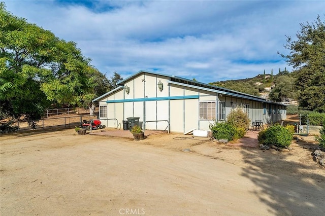 view of side of property featuring fence