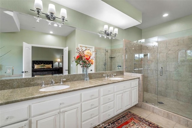 bathroom featuring tile patterned flooring, vanity, and an enclosed shower