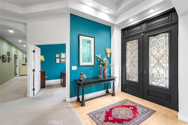 entryway with french doors and light hardwood / wood-style floors