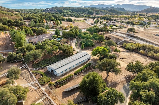 birds eye view of property featuring a mountain view and a rural view