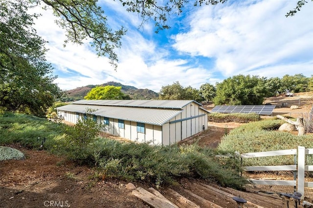 view of home's exterior featuring a mountain view and an outbuilding