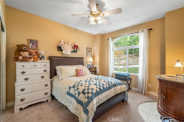 carpeted bedroom with ceiling fan