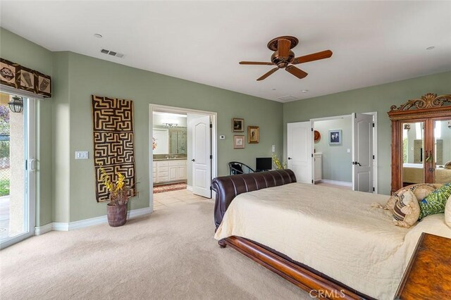 bedroom with connected bathroom, access to outside, ceiling fan, and light colored carpet