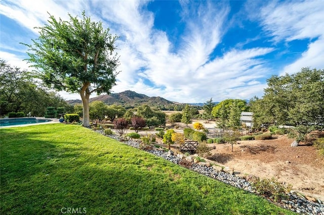 view of yard with an outdoor pool and a mountain view