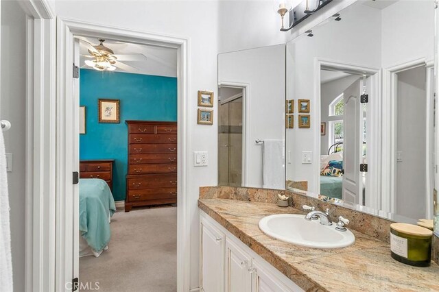 bathroom with a shower, ceiling fan, and vanity