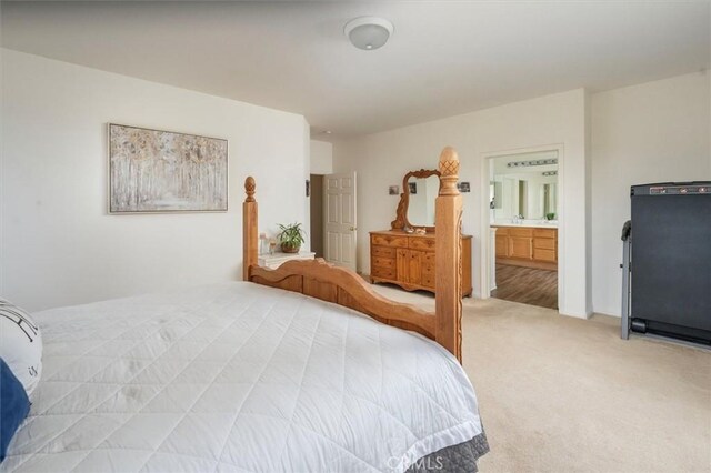 bedroom with carpet flooring and ensuite bath