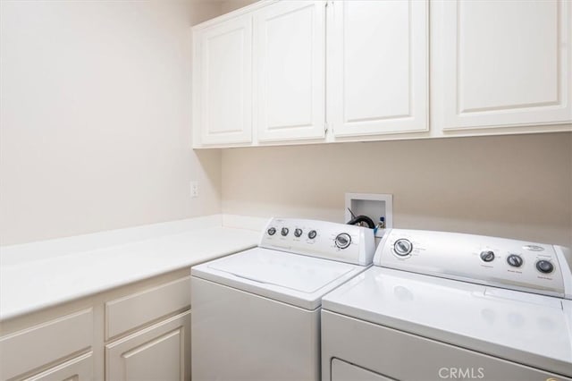 washroom with cabinets and independent washer and dryer