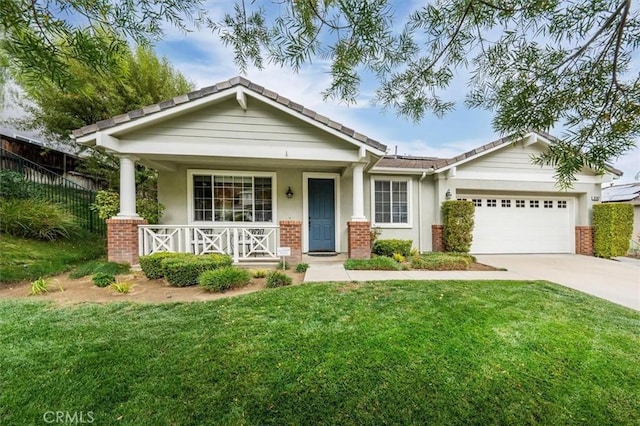 view of front of property with a porch, a garage, and a front yard