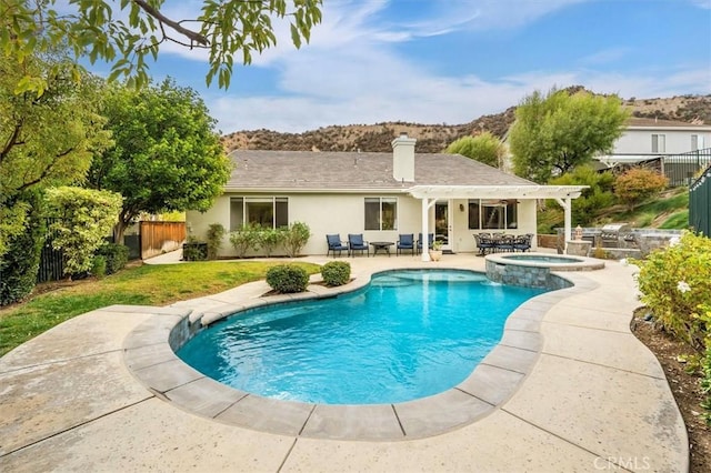 view of swimming pool with a patio area and an in ground hot tub