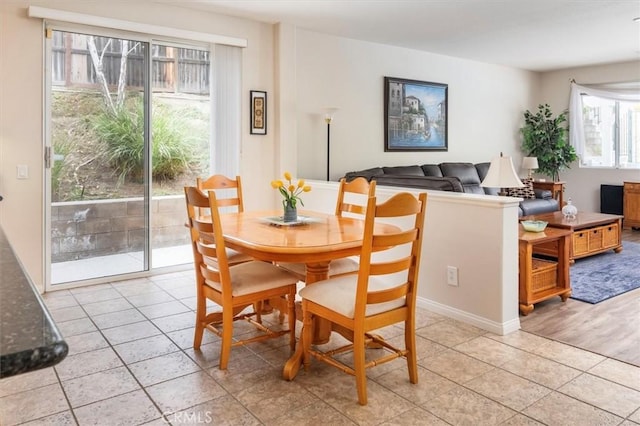 dining space featuring light tile patterned floors