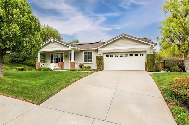 view of front of house featuring a front lawn, covered porch, a garage, and solar panels