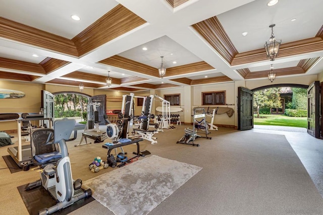 exercise room with crown molding, a healthy amount of sunlight, and coffered ceiling