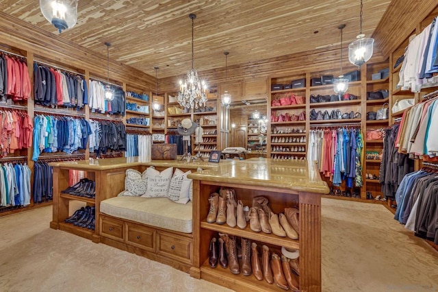 walk in closet featuring a chandelier and light colored carpet