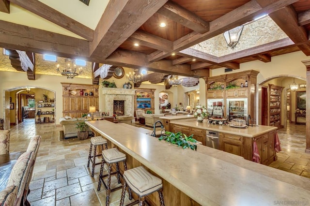 bar featuring a fireplace and beamed ceiling