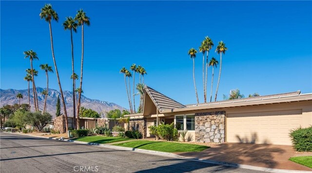 view of front of property with a mountain view and a garage