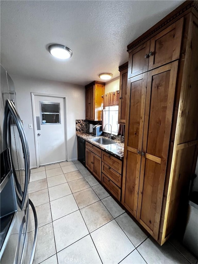 15353 El Centro Rd, Hesperia, CA 92345 - kitchen featuring dishwasher, a sink, refrigerator with ice dispenser, light tile patterned floors, and a textured ceiling