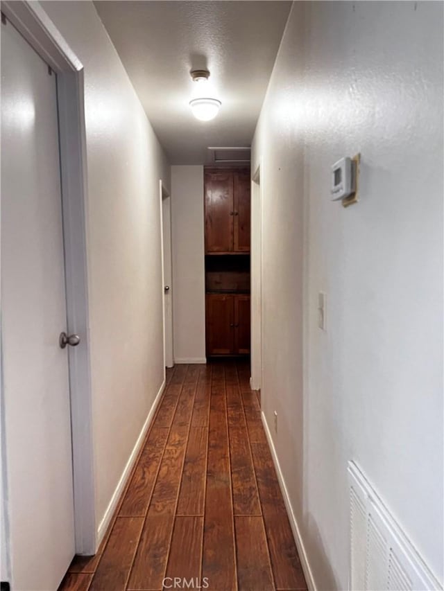 15353 El Centro Rd, Hesperia, CA 92345 - hallway featuring dark wood-style floors and baseboards