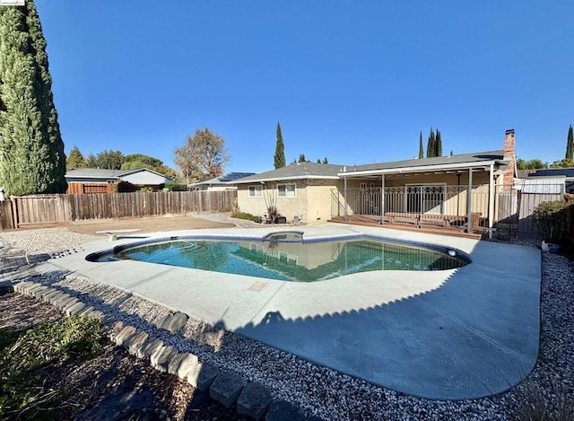 view of pool with a diving board and a patio area