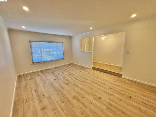 spare room featuring light hardwood / wood-style floors