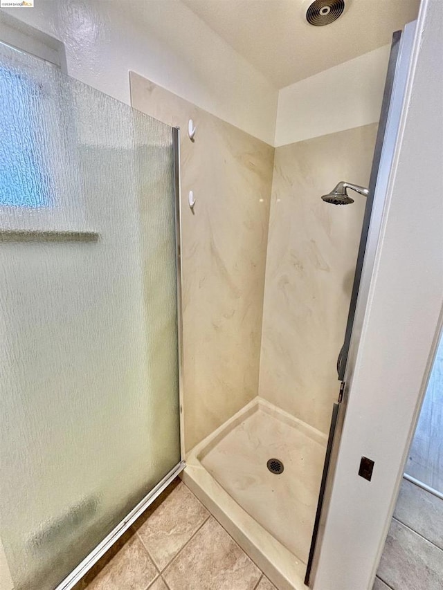 bathroom featuring tile patterned floors and a shower