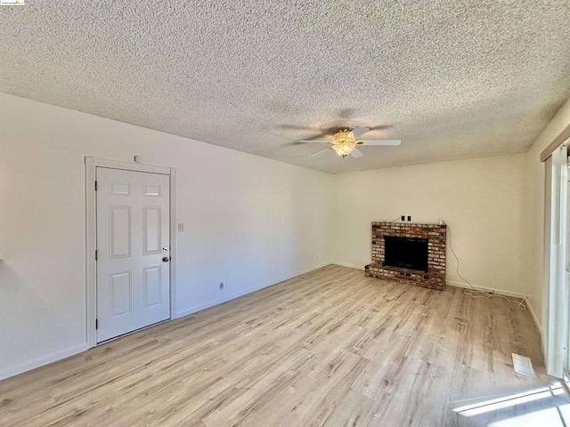 unfurnished living room featuring a textured ceiling, light hardwood / wood-style floors, and ceiling fan