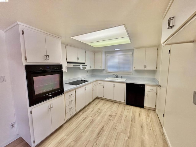 kitchen featuring white cabinets, sink, light hardwood / wood-style flooring, and black appliances