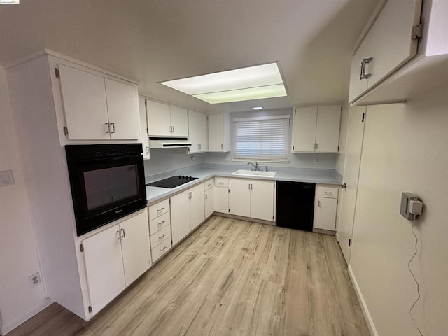 kitchen with white cabinets, light hardwood / wood-style flooring, and black appliances