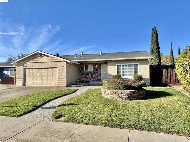 ranch-style home featuring a garage and a front lawn