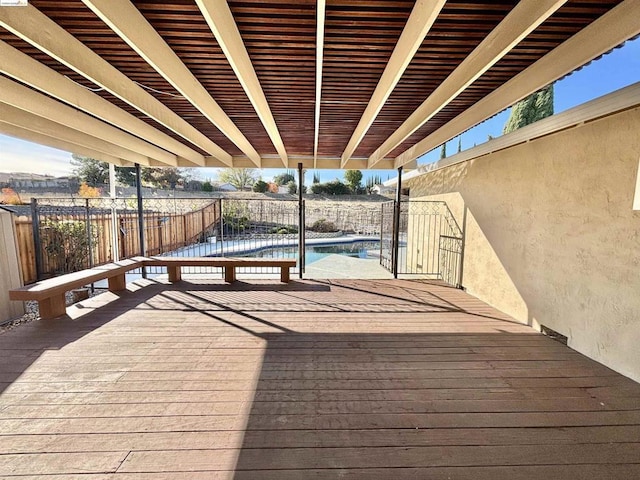 wooden deck featuring a fenced in pool