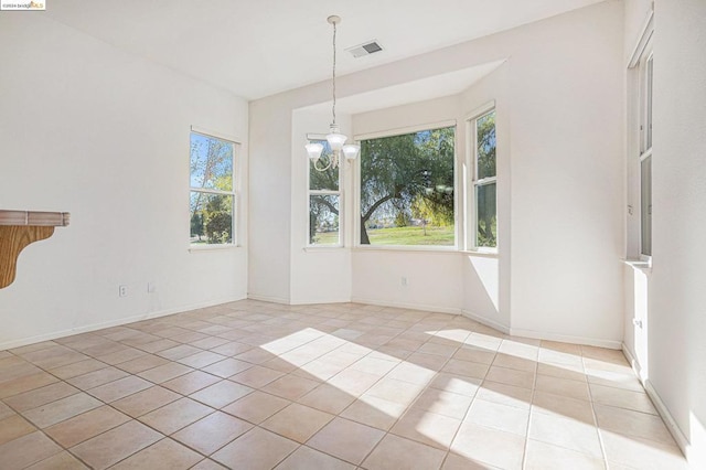 unfurnished dining area with light tile patterned floors and a notable chandelier