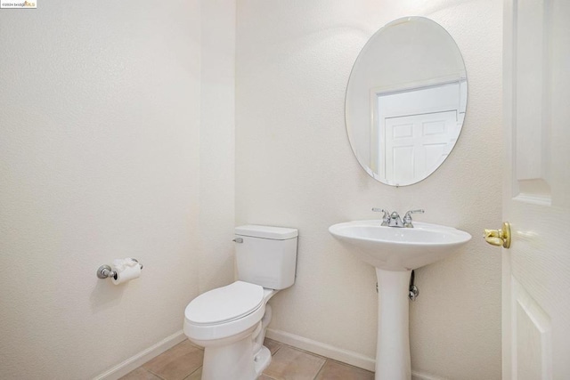 bathroom with tile patterned floors, sink, and toilet