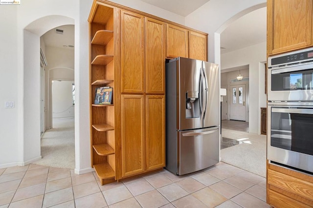 kitchen with light tile patterned flooring and stainless steel appliances