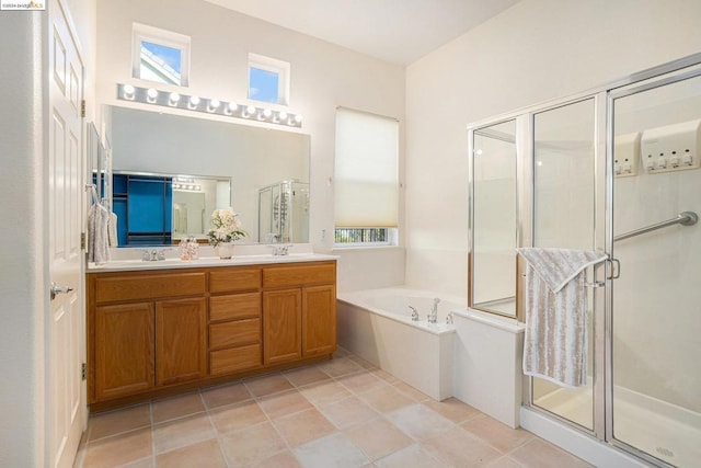 bathroom with tile patterned floors, vanity, a wealth of natural light, and plus walk in shower