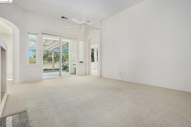 carpeted spare room featuring ceiling fan