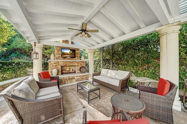 view of patio with an outdoor living space with a fireplace and ceiling fan