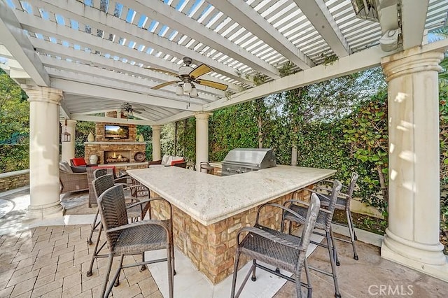 view of patio / terrace featuring a grill, area for grilling, an outdoor bar, and ceiling fan