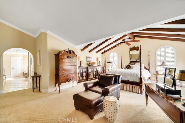 carpeted bedroom with vaulted ceiling with beams and ornamental molding