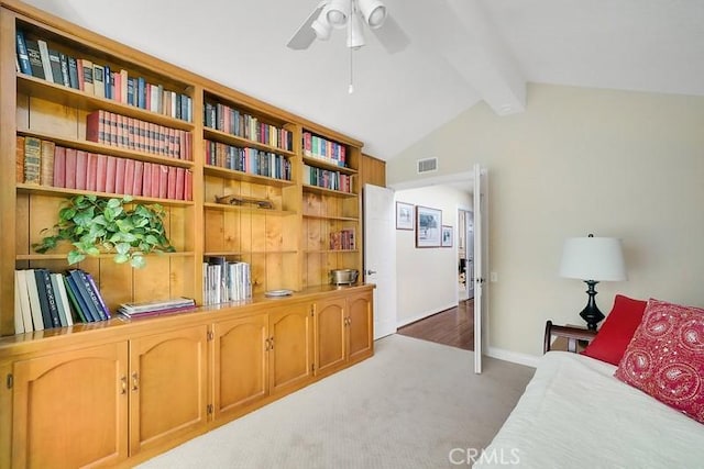 sitting room featuring carpet, lofted ceiling with beams, and ceiling fan