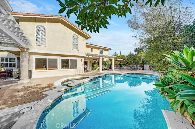 view of pool with a pergola, an in ground hot tub, and a patio