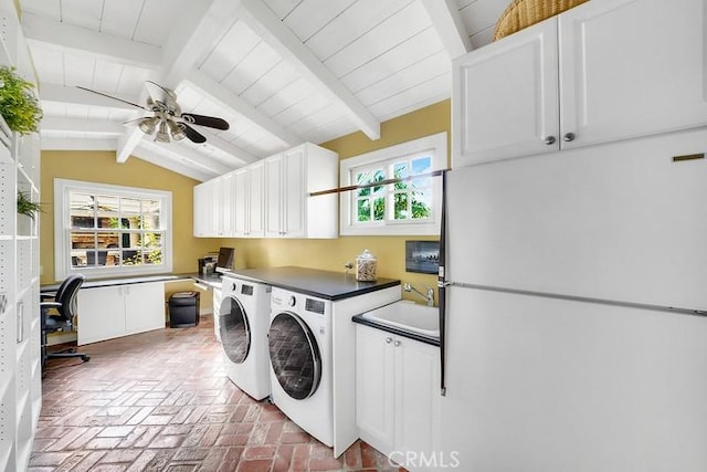 washroom featuring ceiling fan, cabinets, sink, and washing machine and clothes dryer