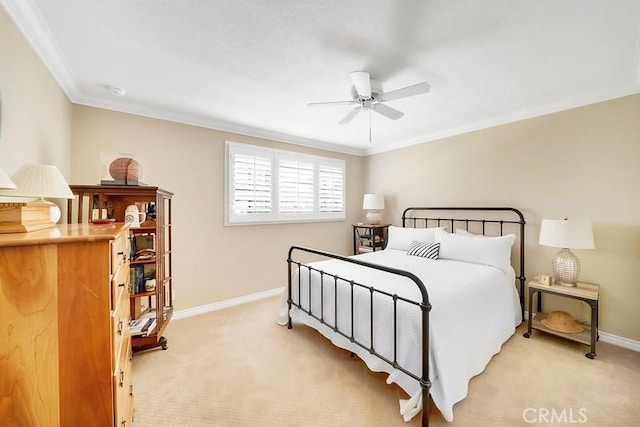 bedroom featuring ceiling fan, crown molding, and light colored carpet