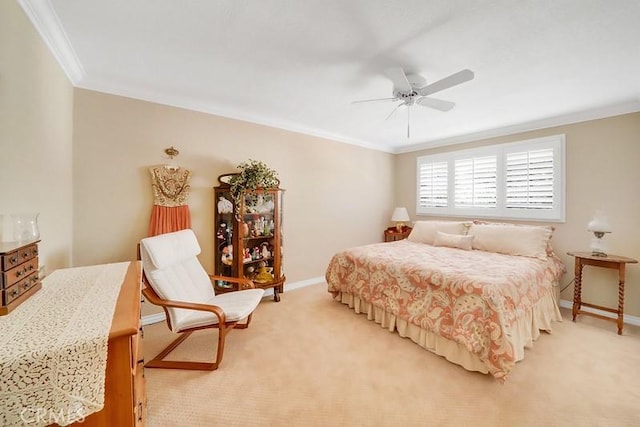 bedroom with ceiling fan, crown molding, and light carpet