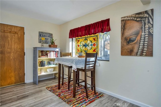 dining area with wood-type flooring