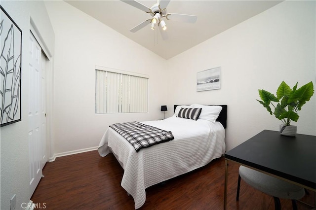 bedroom with lofted ceiling, dark hardwood / wood-style flooring, a closet, and ceiling fan